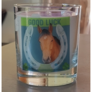 personalised scented candle with a horses head in a horseshoe frame with good luck written above it