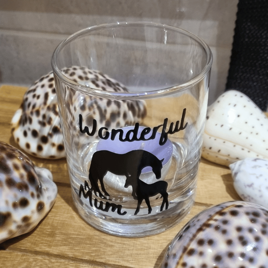 a recycled candle container - an empty glass with wonderful mum horse and foal design with a tealight inside