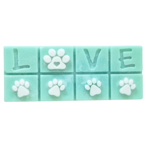 an jasmine coloured soy wax melt bar with LOVE stamped into the top half and white paws on the bottom row